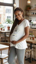 Load image into Gallery viewer, Bee Vee Clean white cotton v-neck t-shirt with playful graphic print, worn by a smiling pregnant woman.
